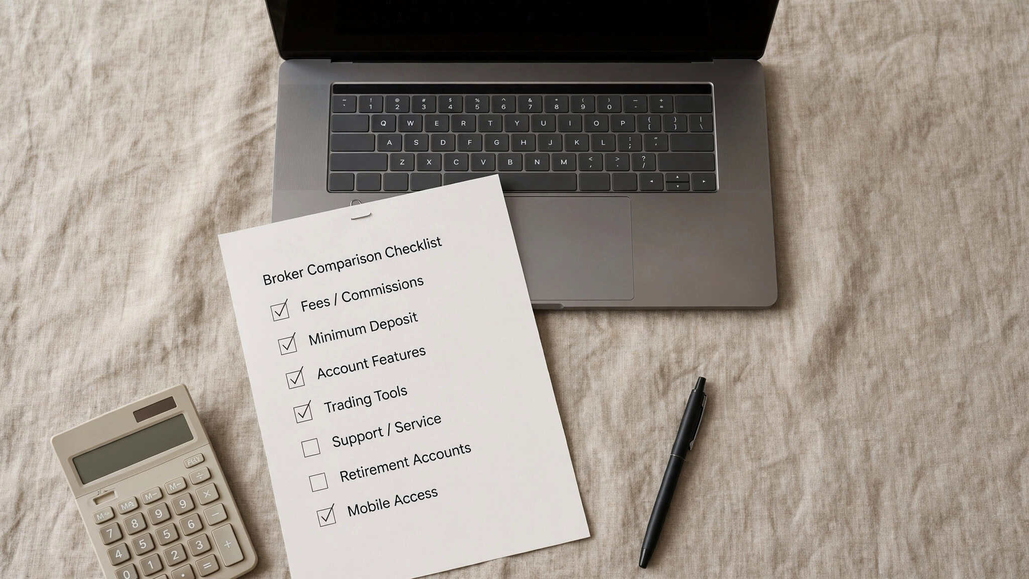Broker comparison checklist flat-lay on a desk